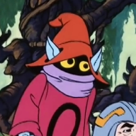 Cropped Image of Orko from Masters of the Universe sitting beside Man at Arms. His gaze is fixed towards something off screen.