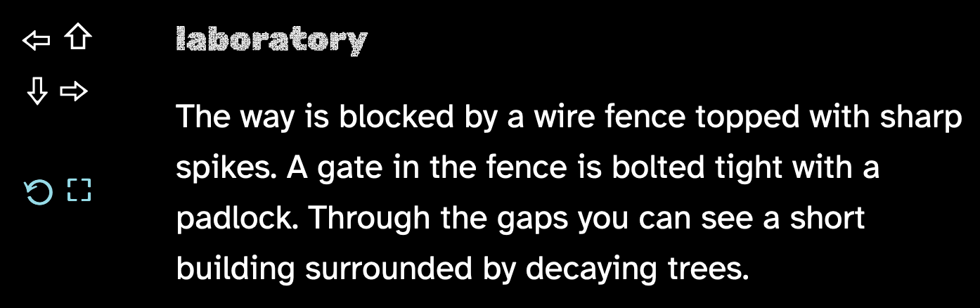 The way is blocked by a wire fence topped with sharp spikes. A gate in the fence is bolted tight with a padlock. Through the gaps you can see a short building surrounded by decaying trees.