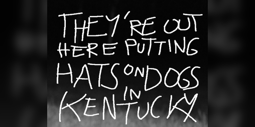 Cover image for THEY'RE OUT HERE PUTTING HATS ON DOGS IN KENTUCKY
