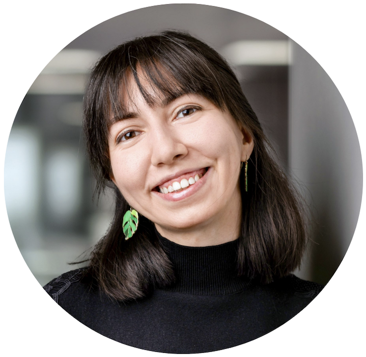 Merve slightly tilts her head, smiling.