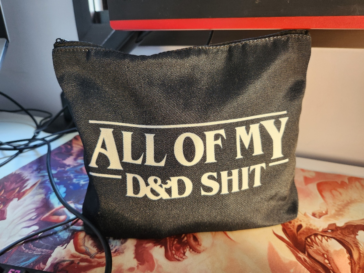 a black bag with the words "All of My D&D Shit" written in white