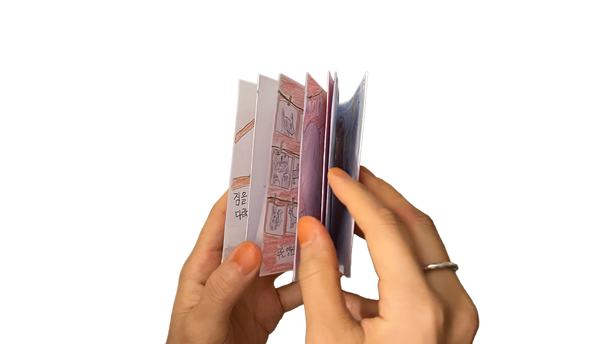 Hands holding zine Hands holding zine