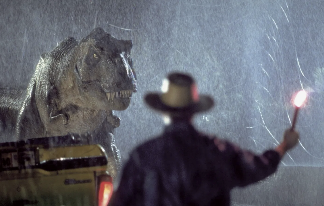 Jurassic Park Still of Man Waving Flare at Dinosaur